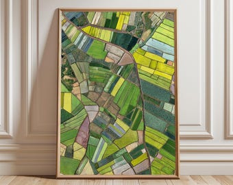 May include: Framed aerial view art print featuring a patchwork of agricultural fields in shades of green, yellow, and brown. The fields are divided by roads and waterways, creating a geometric pattern. The artwork is displayed in a wooden frame.