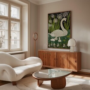 May include: A living room scene featuring a white, curved sofa, a wooden coffee table, and a wooden cabinet. A framed artwork of a swan and cygnets in a pond hangs on the wall. A white lamp and a round mirror complete the decor.