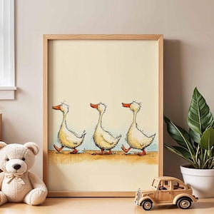 May include: A framed print featuring a whimsical illustration of three ducks walking in a row. The ducks are depicted with yellow bodies, orange beaks, and a light blue and brown background. The frame is made of light brown wood.