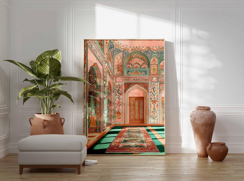 May include: A large framed print of an ornate interior with archways, floral patterns, and a patterned rug. The color palette includes pink, green, and gold. A large potted plant, a gray ottoman, and terracotta vases are in the foreground.