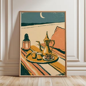May include: A framed art print featuring a stylized illustration of a gold-colored Arabic coffee pot, two small cups, and a plate of dates on a tray. A lantern and a pillow sit on a striped surface under a night sky with a crescent moon.