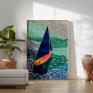 May include: A framed art print showing a sailboat on a sea of blue and green. The sailboat has a dark blue sail, a pink and yellow hull, and is set against a backdrop of stylized waves. The artwork is displayed in a room with a plant, ottoman, and decorative vases.