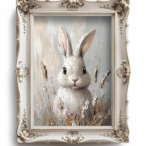 May include: A white rabbit with long ears sits in a field of tall grass and flowers. The rabbit is looking directly at the viewer. The painting is framed in a white ornate frame.
