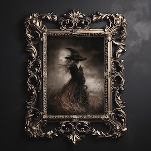 May include: Ornate gold-colored framed artwork featuring a witch in a long dress and hat, holding a black cat. The artwork is set in a field with tall grass, under a cloudy sky. The frame has intricate scrollwork and a dark background.