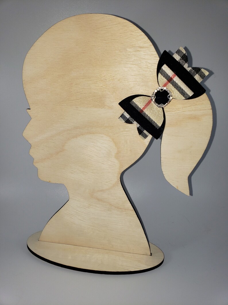 Beautiful black and beige plaid hair bow for toddlers and girls with a black rhinestone center .