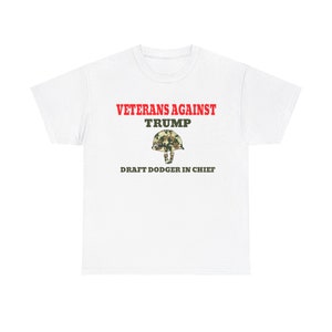 May include: White t-shirt with red text that reads "Veterans Against Trump" and a camouflage helmet graphic. The text below the graphic reads "Draft Dodger in Chief."