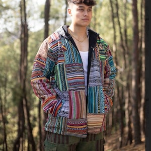 May include: A multi-coloured patchwork jacket with a zip closure and a hood. The jacket is made of a soft, comfortable fabric and features a variety of geometric patterns.