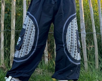 May include: Black pants with a wide leg and a drawstring waist. The pants have a white and gray geometric pattern on the sides.