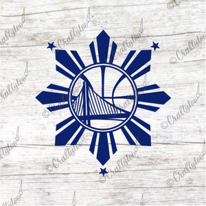 May include: A blue silhouette of a basketball with a bridge inside, surrounded by a sunburst design with eight points and two stars. The design is reminiscent of the flag of the Philippines.