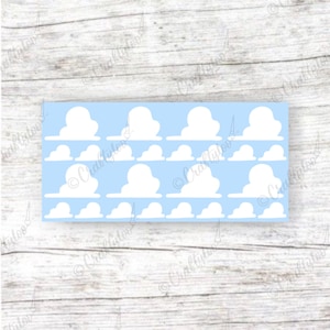 May include: A rectangular sheet featuring a repeating pattern of white cloud shapes arranged in two rows against a light blue background. The design consists of larger, rounded cloud motifs interspersed with smaller, simpler cloud silhouettes.