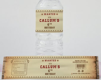 May include: A brown and tan paper water bottle label with red text that says "WANTED IT'S CALLUM'S 6TH BIRTHDAY". The label has a wood grain background and stars around the border.