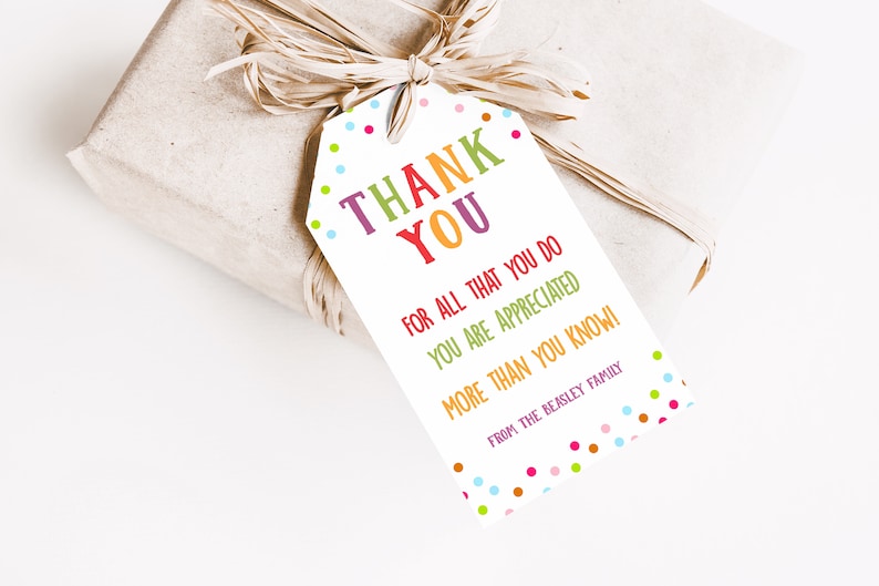 May include: A gift wrapped in brown paper, tied with raffia, and a tag that says "THANK YOU" in colorful letters. The tag also includes the phrases "FOR ALL THAT YOU DO", "YOU ARE APPRECIATED", and "MORE THAN YOU KNOW!"