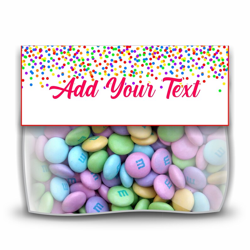 May include: A clear plastic bag filled with pastel-colored M&M's candies. The bag has a white label with a red border and the text "Add Your Text" in pink cursive writing. The label is decorated with a rainbow confetti pattern.