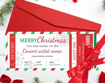 Può includere: Un biglietto rosso per un concerto di Natale con dettagli verdi e bianchi, in una busta rossa. Il biglietto recita "Merry Christmas" e "You are going to see Concert artist name." Un nastro rosso e decorazioni natalizie circondano il biglietto.