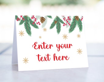 May include: White folded card with a festive Christmas design. The top edge features green pine branches, red berries, and pine cones. Gold snowflakes and the text "Enter your text here" in red complete the design.