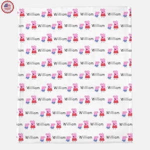 May include: White fabric with a repeating pattern of pink pigs with red shirts and blue pants. The text "William" is repeated throughout the pattern.