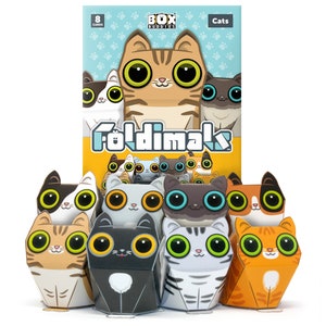 May include: A set of eight paper fold-out cat figurines. The cats are in various colours and patterns, including orange, black, white, and grey. The box says "Foldimak" and "Cats".