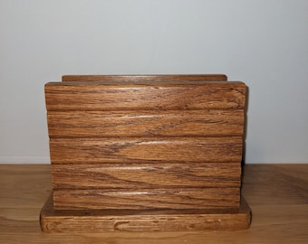 May include: A wooden coaster set with a natural brown finish. The coasters are stacked on top of each other and have a rectangular shape.