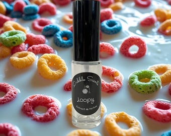 May include: A perfume bottle with a black cap and a label reading "Loopy" by Dabble Scents, is surrounded by colourful cereal pieces in milk. The cereal pieces are red, yellow, green, and blue.
