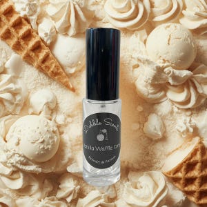 May include: A clear glass perfume bottle with a black cap, labeled "Dabble Scents Vanilla Waffle Cone Extrait de Parfum." The bottle is surrounded by waffle cones, whipped cream, and ice cream scoops, all in shades of white and beige.