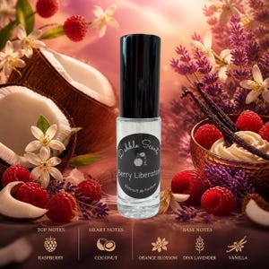 May include: A clear glass perfume roller bottle with a black cap and a circular label reading Dabble Scents Berry Liberation Extrait de Parfum. The bottle is centered, surrounded by images of raspberries, coconut, orange blossoms, lavender, and vanilla.
