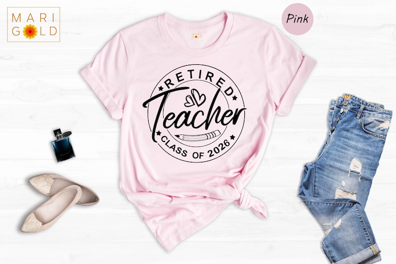 a pink t-shirt with a graphic design, a pair of blue jeans, and some accessories such as a perfume bottle and a pair of shoes, all laid out on a white background.