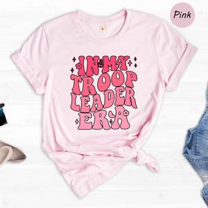a pink t - shirt with the words think about the leader era printed on it