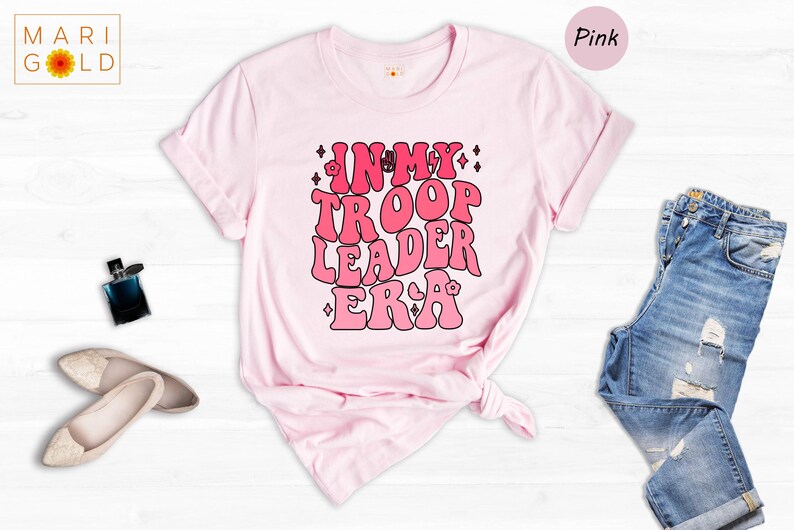 a pink t - shirt with the words think about the leader era printed on it