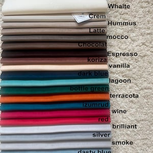 May include: A fabric swatch book displaying 14 different colours of velour fabric. The colours are: white, cream, hummus, latte, mocco, chocolate, espresso, vanilla, dark blue, lagoon, bottle green, terracotta, izumrud, wine, red, brilliant, silver, smoke, dusty blue, pale lavender, and violet. The fabric is water-resistant and anti-vandal.