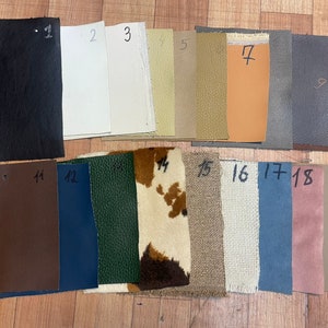 May include: A collection of 18 fabric swatches in various colours and textures, including black, white, beige, brown, green, blue, and pink. The swatches are numbered 1 through 18.