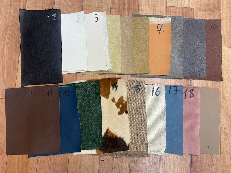 May include: A collection of 18 fabric swatches in various colours and textures, including black, white, beige, brown, green, blue, and pink. The swatches are numbered 1 through 18.