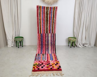 May include: A long, colorful rug with a striped pattern and a checkered design. The rug is made of wool and has a fringe on the ends.