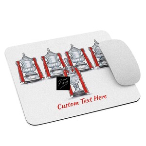 May include: White mousepad with a hand-drawn illustration of silver trophies with red ribbons. The words "Custom Text Here" are in red. A white computer mouse is on the right side of the mousepad.