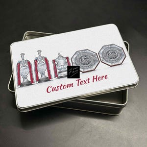 May include: A rectangular metal tin with a white lid featuring illustrations of trophies and the text "Custom Text Here" in burgundy. The tin is open, revealing its interior.