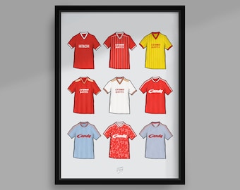 May include: A framed collage of nine different Liverpool Football Club jerseys, showcasing the team's kits from various eras. The jerseys feature different sponsors, including Hitachi, Crown Paints, and Candy.