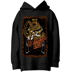 May include: Black hoodie with a graphic print of two guns crossed over the text "The Charlie Daniels Band" in orange and yellow lettering on a brown leopard print background.