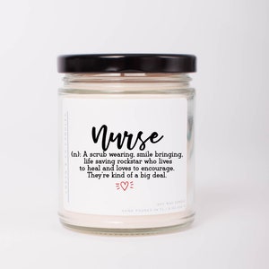 May include: A glass jar candle with a black lid and a white label that reads "Nurse (n): A scrub wearing, smile bringing, life saving rockstar who lives to heal and loves to encourage. They're kind of a big deal."