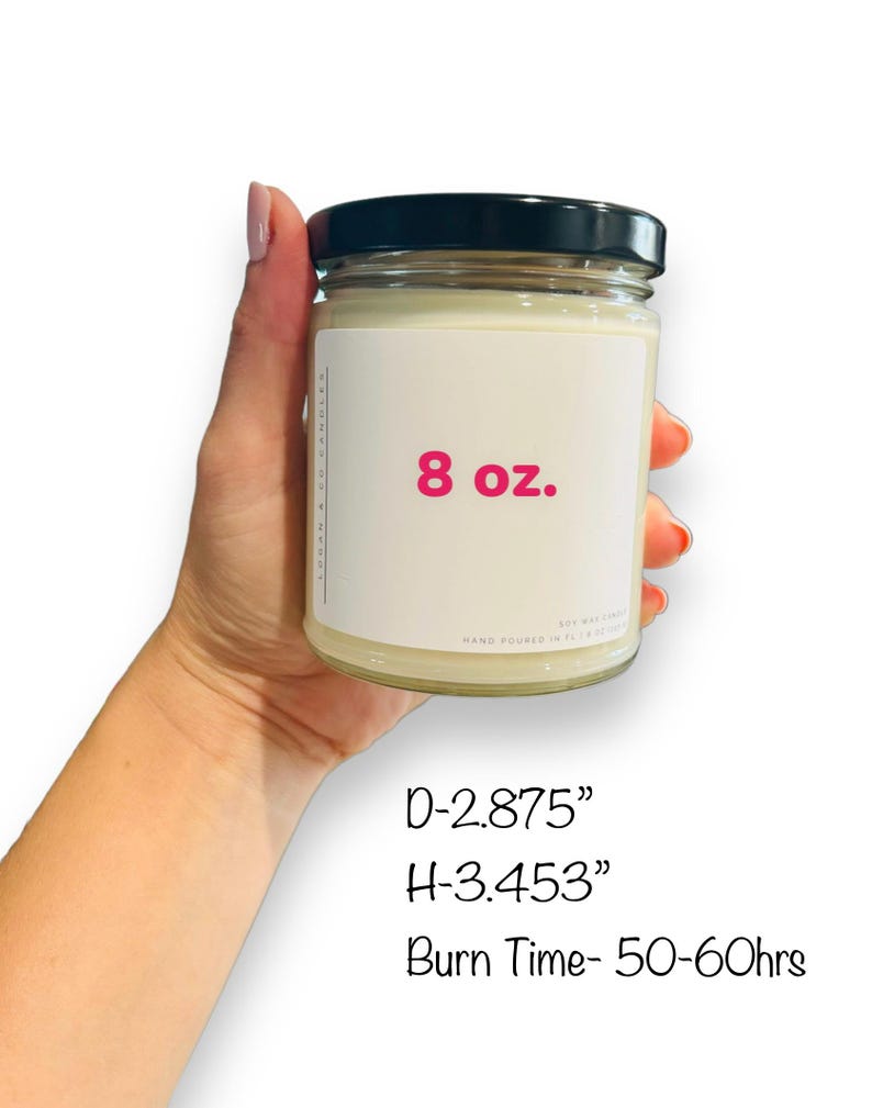 May include: A clear glass candle jar with a black lid. The jar is labeled "8 oz." and has a pink font. The candle is hand-poured and has a burn time of 50-60 hours. The jar is 2.875 inches in diameter and 3.453 inches in height.
