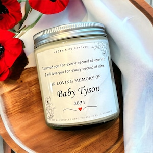 May include: White soy wax candle with a silver lid. The label reads "LOGAN & CO. CANDLES" and includes the text "I carried you for every second of your life I will love you for every second of mine IN LOVING MEMORY OF Baby Tyson 2024".