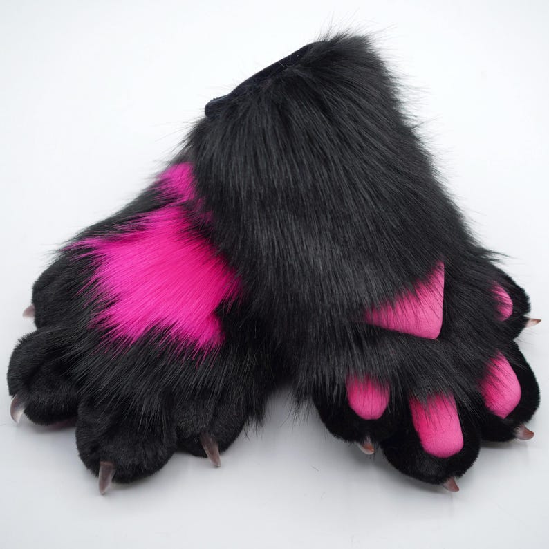 May include: A pair of black furry paws with pink accents. The paws have claws and are designed to look like animal paws.