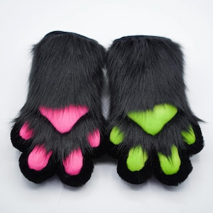 May include: A pair of black furry paw hand puppets with pink and green paw pads.