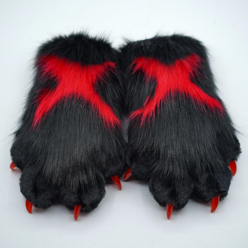 May include: A pair of black furry hand paws with red claws and red X markings on the back.