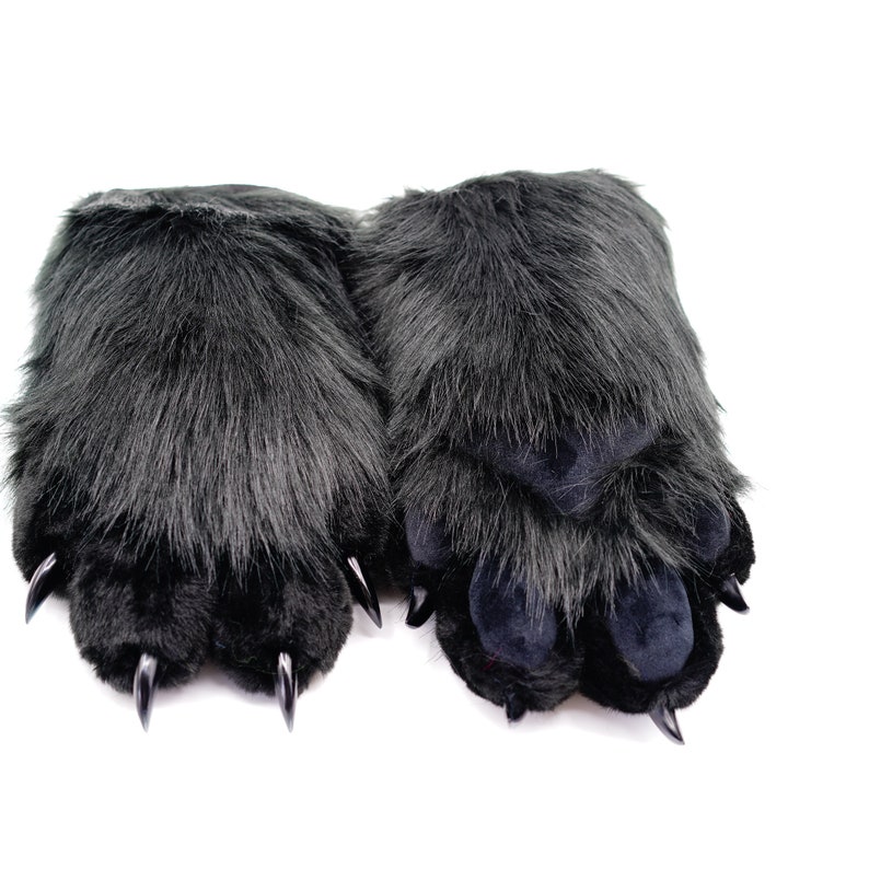 May include: A pair of black plush paw-shaped hand warmers with black claws.
