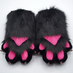May include: A pair of black furry paw hand warmers with pink paw pads.