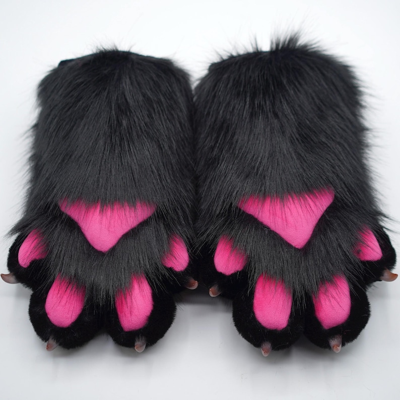 May include: A pair of black furry paw hand warmers with pink paw pads.