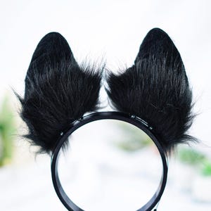 May include: Black furry cat ears headband with a black plastic headband.