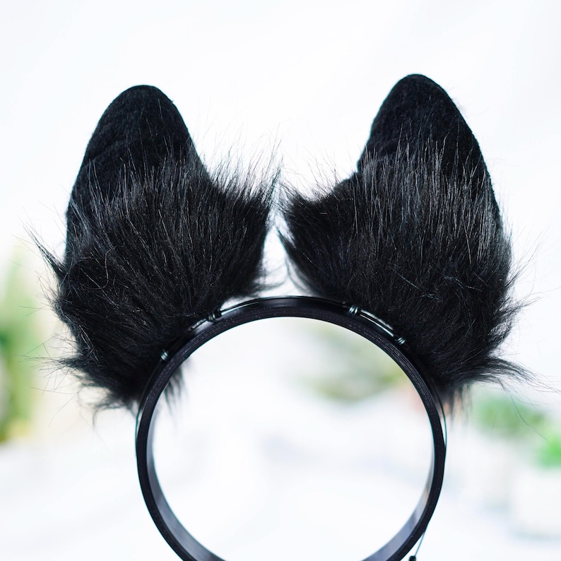 May include: Black furry cat ears headband with a black plastic headband.