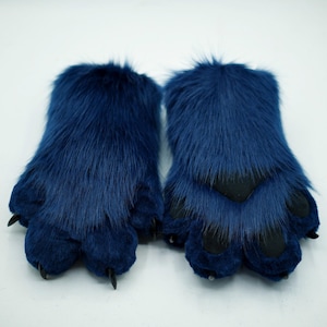 May include: A pair of blue furry paw hand puppets with black claws.