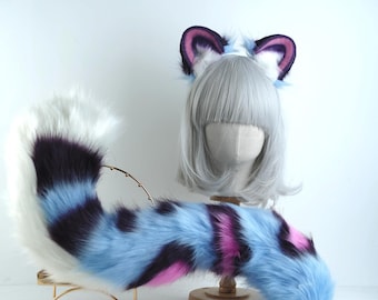 May include: A cosplay set with a fluffy tail and cat ears. The tail is striped in blue, purple, and pink, and is supported by a gold-coloured metal stand. The ears, with purple and pink accents, are attached to a headband. A costume accessory.