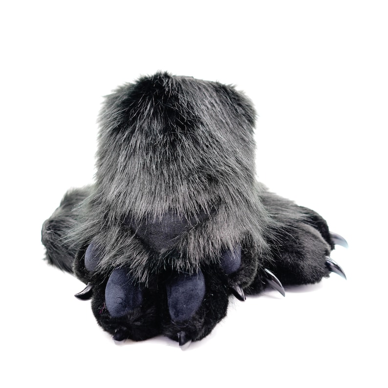 May include: Black furry slippers with paw-shaped toes and claws. The slippers are made of soft, plush material and are designed to look like animal paws.